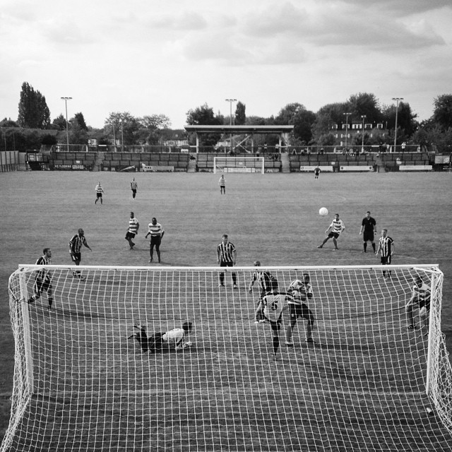 A Tooting & Mitcham United defender clears off the line during their pre-season friendly with Kingstonian