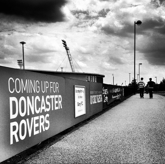 Two Doncaster Rovers fans arrive at the Keepmoat Stadium for Doncaster Rovers match versus Bury