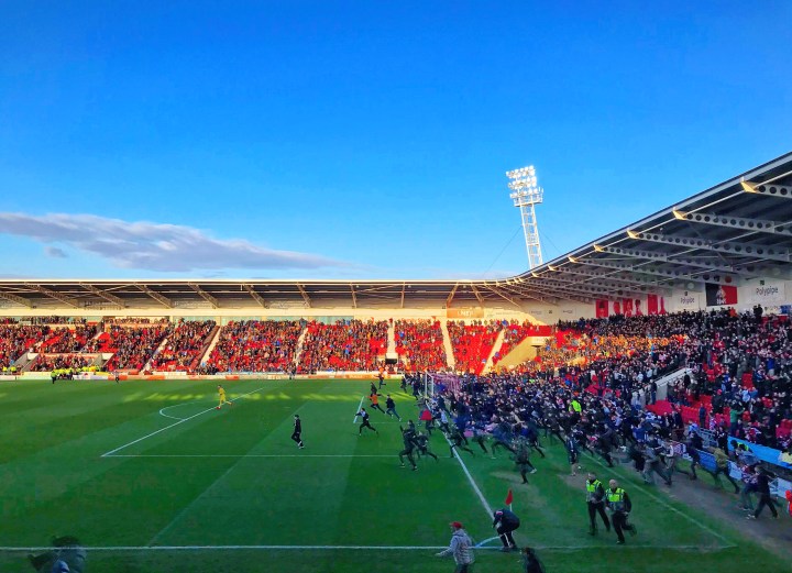 Supporters invade the pitch at the Keepmoat Stadium following Doncaster Rovers 2-0 victory over Coventry City to secure a League One play-off place.