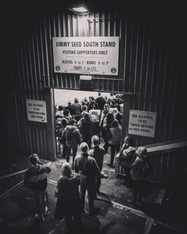 Doncaster Rovers supporters have one last cigarette before the penalty shoot out in the League One Play Off Semi-Final second leg at The Valley