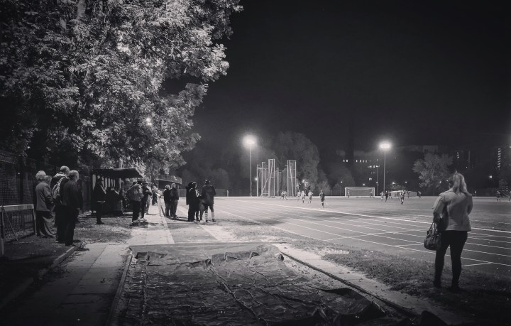 Spectators watch on under the floodlights during the first Ladywell-classico of the season in Southern Counties East League Division One