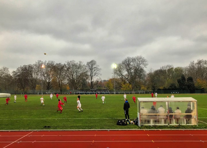 The visiting bench watches on as two players wait for the ball to drop during the Southern Counties East League Division One match at Ladywell Arena