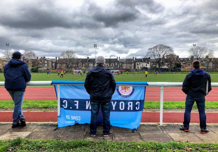 A Croydon supporter with flag, watches his team win at Lewisham Borough