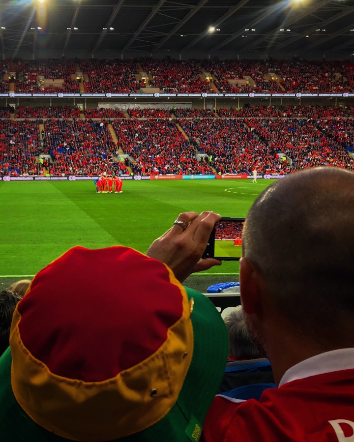A supporter photographs the Wales' team's huddle before their Euro 2020 qualifier at home to Azerbaijan