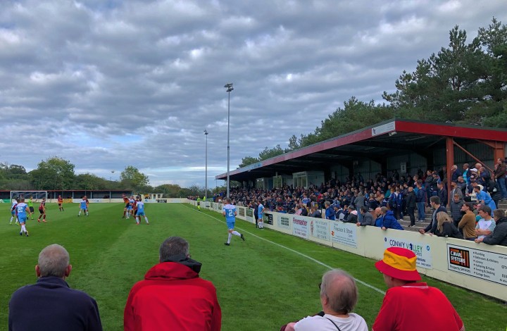 A large crowd watches Colwyn Bay take on Cardiff Met at Llanelian Road
