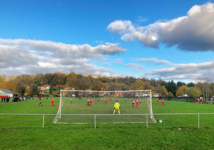 The Albion Rovers goalkeeper gets ready for a Cwmbran Town attack, as seen from behind the Albion Rovers goal