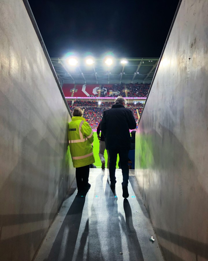 A spectator enters the Cardiff City Stadium from the concourse