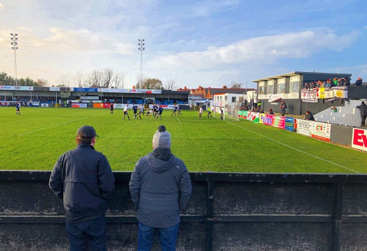 Two spectators watch on as Y Rhyl 1879 take on Llannefydd at Belle Vue