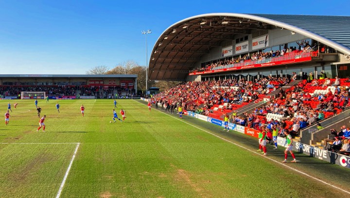 Doncaster Rovers Josh Martin runs at the Fleetwood Town defence in front of the large main stand at Highbury Stadium