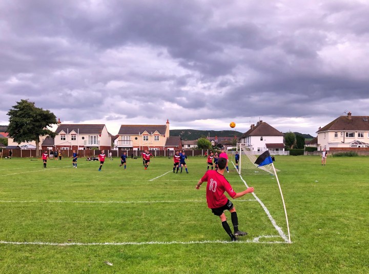 Penrhyn Bay Dragons number 10 delivers a corner kick in a match against Llandudno Amateurs at The Oval
