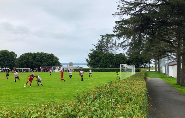 A Llanrwst United forward holds off a Llanfairfechan Town defender during a Welsh Cup match