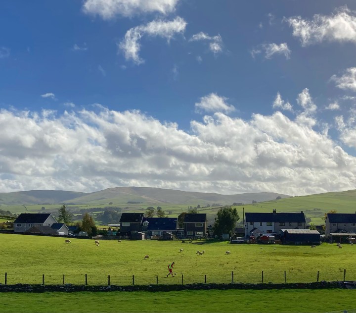 A substitute collects an errant football from a field next to Cerrigydrudion's home pitch