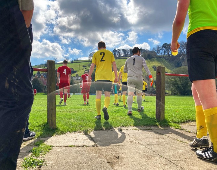 The players of Knighton Town and Aberaeron enter the field at the former's ground