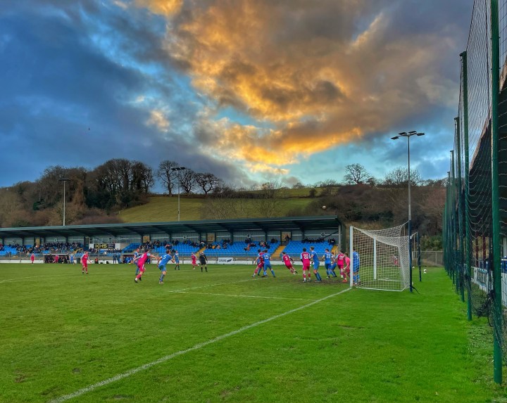 The sun sets over Colwyn Bay's Llanelian Road ground during their match against Mold