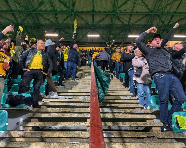 Home fans celebrate as GKS Katowice go 2-1 up against Widzew Łódź on a rainy evening