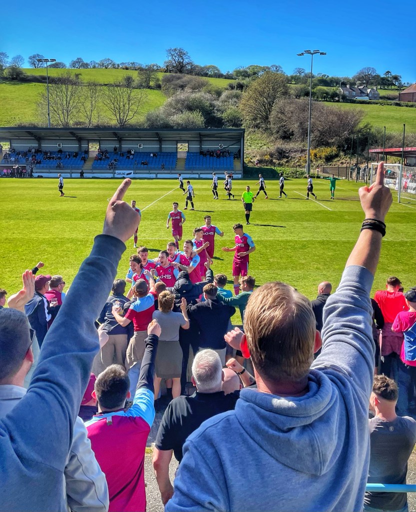 Colwyn Bay players celebrate with their fans after going 1-0 up against Llandudno