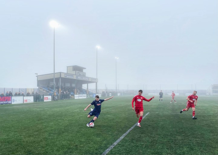 An Airbus winger looks to get in a cross against Buckley in a match shrouded in thick fog