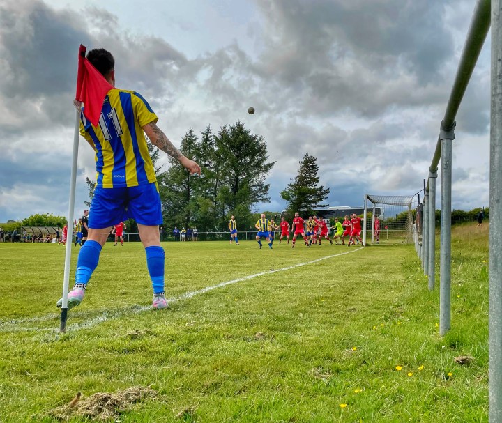 Penmaenmawr Phoenix' number 11 swings a corner into a crowded penalty area away at Cerrigydrudion