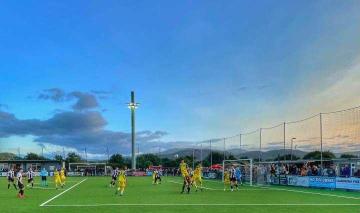A Colwyn Bay heads clear during their match at Llandudno