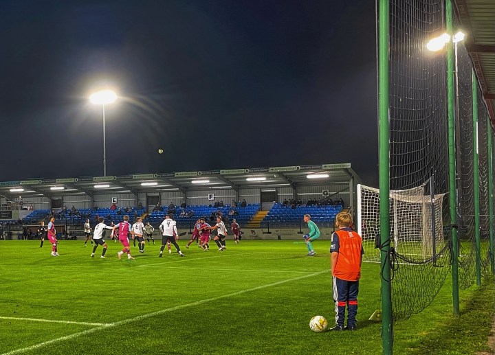 A young ballboy watches on during a night match at Colwyn Bay