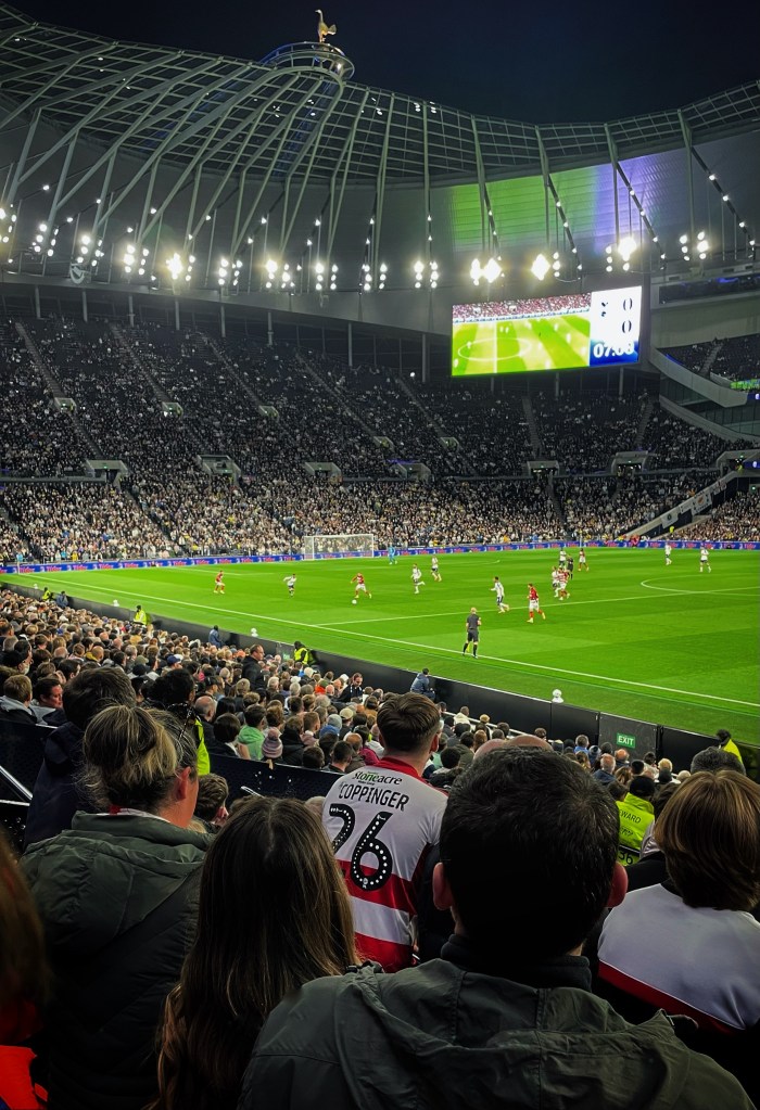 A Doncaster Rovers fan's 'Coppinger 26' shirt stands out in a huge crowd watching Rovers League Cup defeat at Tottenham.