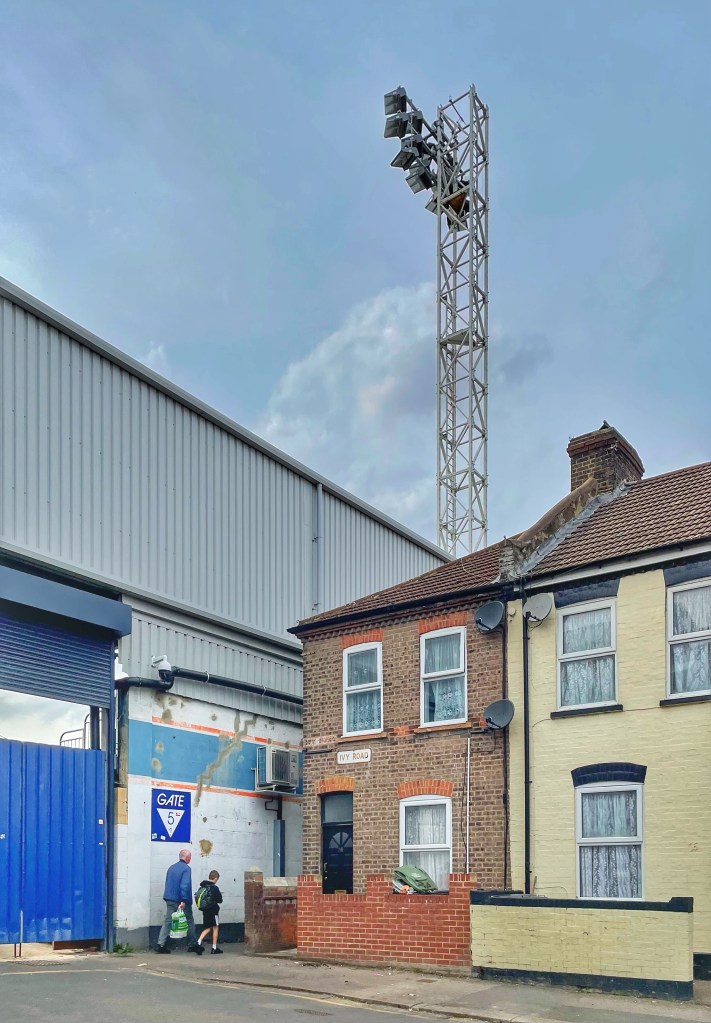 An old man and a young boy head down a narrow alleyway between Luton Town's Kenilworth Road ground and neighbouring houses.