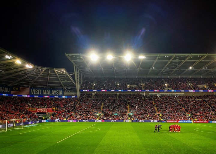 The Wales players have a pre-match huddle on the pitch before their World Cup qualifier with Belgium.