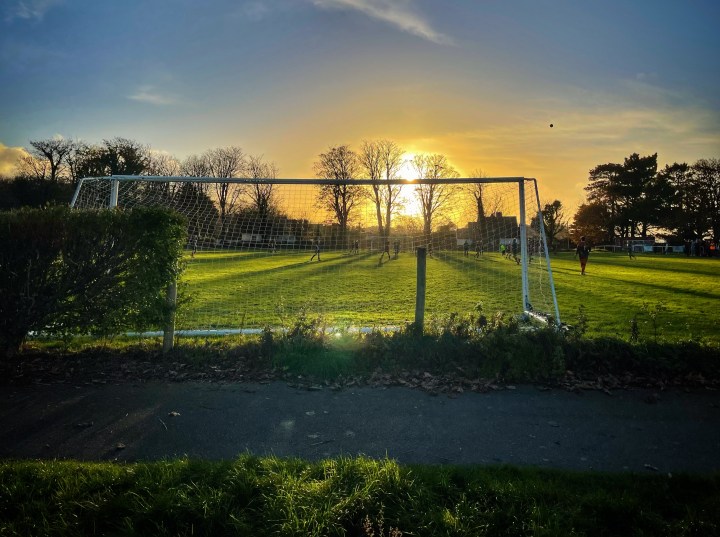 The ball disappears into a low autumn sun above the pitch as Llanfairfechan Town host Y Glannau.