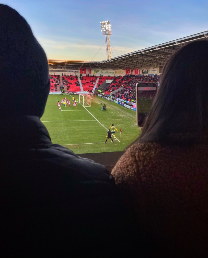 A Doncaster Rovers supporter catches the action on her phone as Southampton take a first half corner at the Eco Power Stadium.