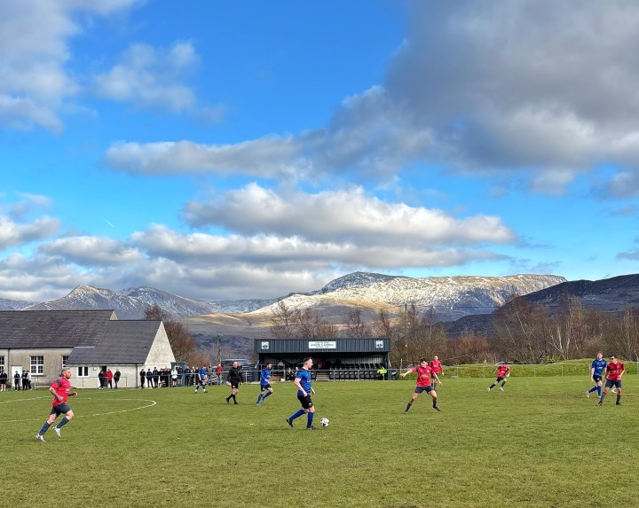 Mynydd Llandegai and Llanerch-y-Medd play against a backdrop of snow-topped mountains at the former's Penrhiw home ground.