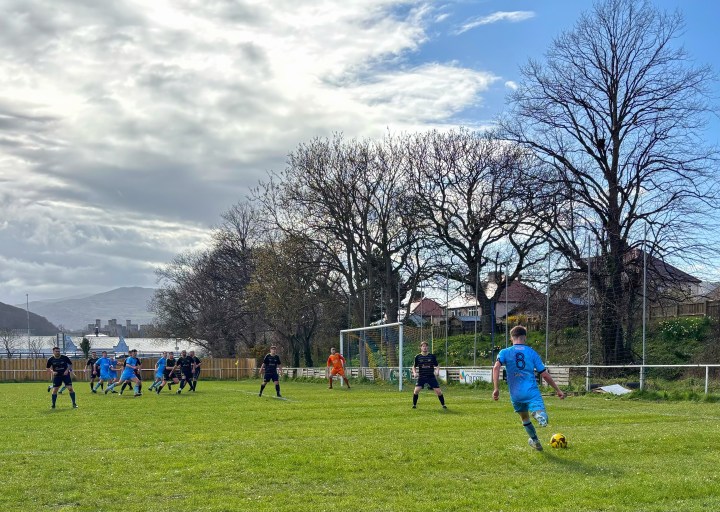 Conwy Borough take an attacking free-kick during their away win at Llandudno Junction. Conwy Castle is visible in the background.