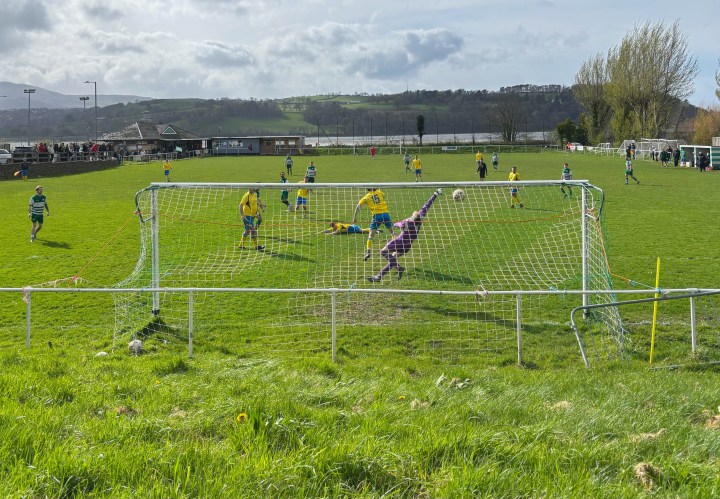 Mochdre Sports's second goal sails just beyond the desperate reach of the Glan Conwy goalkeeper during their 3-1 win at the latter team's Cae Ffwt ground.