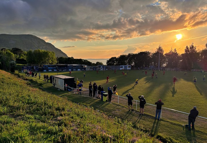 The sun sets over the sea during a late season evening match at Penmaenmawr Phoenix.